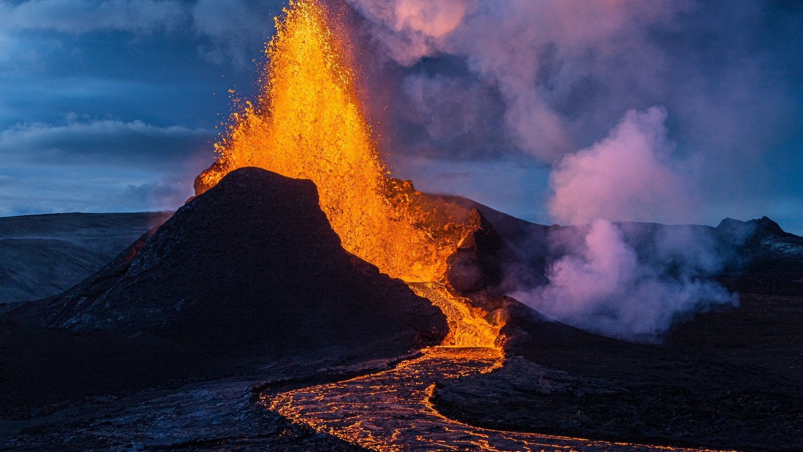 A volcano erupting with lava flowing out